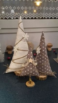 two small christmas trees sitting on top of a table