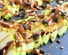 sliced apples with nuts and caramel drizzled on them