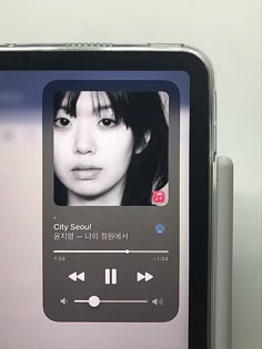 an mp3 player is shown on the screen in front of another device that also displays music