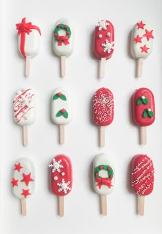 christmas themed pops are arranged in rows on a white surface