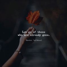 someone holding a leaf in their hand with the quote let go of those who are already gone