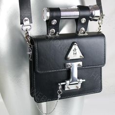 Industrial design Goth Steampunk black leather shoulder bag, evening bag, satchel with torch as a handle.Has removable shoulder strap with shoulder pad, and the torch can be used as the handle.True piece of art and conversation starterBag is vintage, material is genuine leather from ItalyPerforated stainless steel logoTorch as a handleThe torch works.2 x batteries of AAA are required, batteries are not included as the we cannot send these batteries overseasWidth of the bag is 20.50 cm or 8.125 i Futuristic Purse, Goth Industrial, Unusual Handbags, Goth Steampunk, Handbag Satchel, Industrial Steampunk, Statement Art, Black Leather Crossbody Bag, Evening Handbag