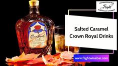 a bottle of crown royal drinks next to autumn leaves and a glass with liquid in it