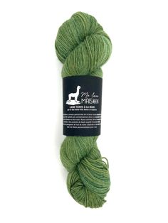 a skein of green yarn on a white background with the label for woolwool