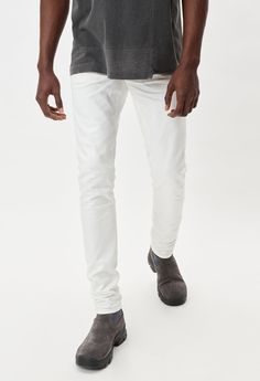 Japanese 3x1 woven stretch denim in white. Unwashed, raw denim with 3D whiskering and tonal stitching. Slim tapered fit with a low rise in the front and higher rise in the back. Made in Japan. 98% Cotton / 2% Poly. John Elliott, Raw Denim, The Cast, Made In Japan, Stretch Denim, Low Rise, It Cast, Stitching, Slim Fit