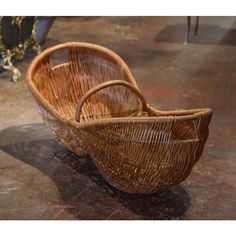 a wicker baby carriage sitting on top of a floor