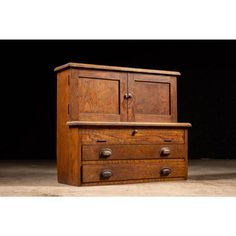 an old wooden dresser with two drawers on it's front and one drawer open