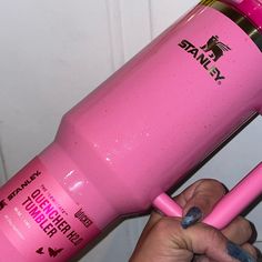 a person holding a pink hair dryer in their hand