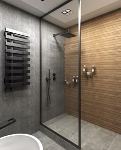 a bathroom with a glass shower door and wooden wall