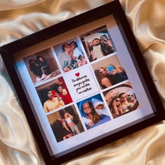 a black framed photo with many pictures in it on a white satin background, and the words love is all around