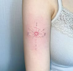 a woman's arm with a tattoo on it that has a heart in the middle