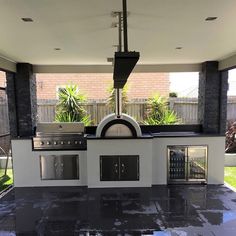 an outdoor kitchen with black and white tile