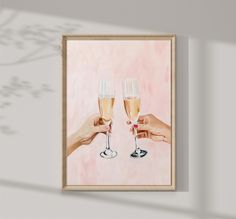 two hands holding champagne glasses in front of a pink background