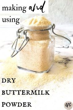 a jar filled with dry butter sitting on top of a counter next to a sign that says making and using dry buttermik powder