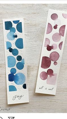 two bookmarks with watercolor designs on them