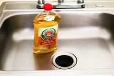 a bottle of liquid sitting on top of a sink