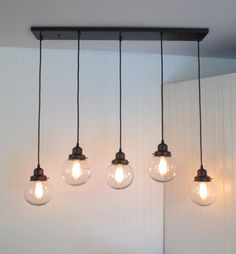 five light bulbs are hanging from the ceiling