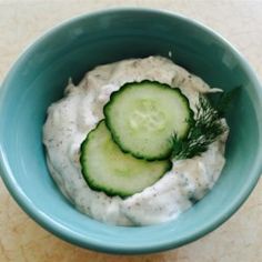 a bowl filled with cucumber and ranch dressing