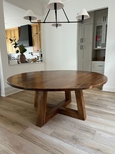 a large wooden table sitting on top of a hard wood floor