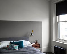 a bedroom with gray walls and white trim