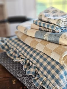 a stack of folded towels sitting on top of a wooden table