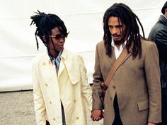 two men with dreadlocks standing next to each other