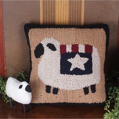 a sheep pillow sitting on top of a wooden table