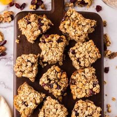 oatmeal granola bars on a baking tray with oranges and cranberries