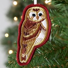 an owl ornament hanging from a christmas tree