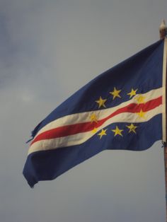 a flag flying in the wind on a cloudy day