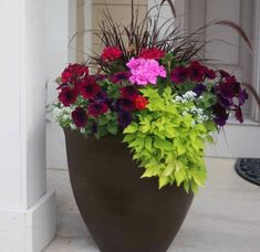 a large potted planter filled with colorful flowers