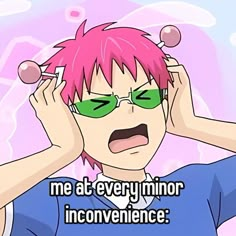 a person with pink hair and green glasses holding their hands up to their ears while looking at the camera