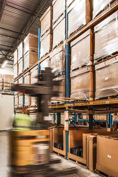 a warehouse filled with lots of boxes and moving machinery