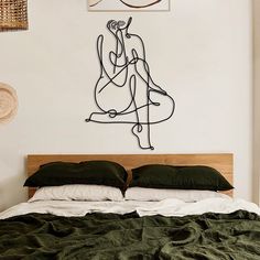 a bedroom with a bed and artwork on the wall