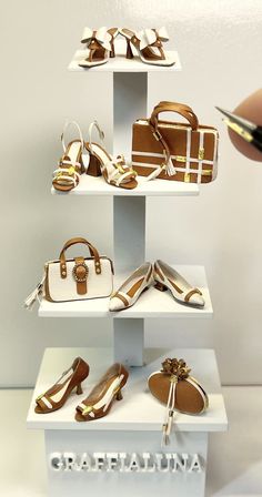 there are many shoes and purses on display