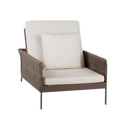 a brown and white chair with pillows on it