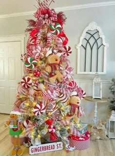 a christmas tree decorated with candy canes, gingerbread and other holiday decor items