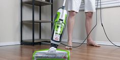 a man is using a vacuum cleaner on the floor