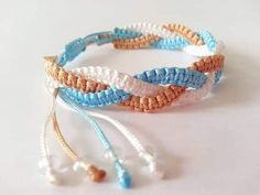 three bracelets with beads and tassels on a white surface, one has a beaded cord