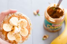 a person holding a banana and peanut butter snack