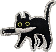 an embroidered black cat with green eyes