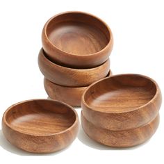 four wooden bowls stacked on top of each other