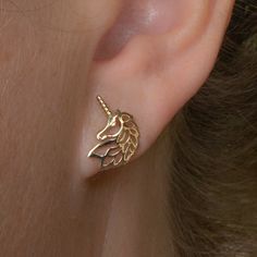 The perfect earring doesn't exis  How adorable are these gold unicorn studs?!  Made of solid 10K Gold our unicorn studs are a fun addition to your jewelry box.  Embrace your cottage core style and add these unicorn studs to your ear-scape.  * ＤＥＴＡＩＬＳ: - 10K SOLID Gold  - Perfect for sensitive ears - Size: 9mm x 13mm - 1 grams - Ships next business day - Made in Oakville, ON.  * C A R E:  - gently clean with warm water and baking soda  - use a toothbrush to scrub lightly  - use a polishing cloth Ear Scape, Cottage Core Style, Unicorn Earrings, Cute Rings, Sensitive Ears, 10k Gold, Cottage Core, Earrings Gold, Jewelry Earrings Studs