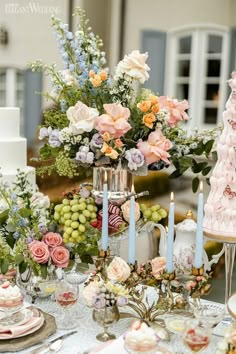 a table topped with lots of different types of cakes and desserts covered in frosting