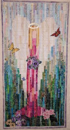 a quilt made to look like a tall building with butterflies on it and flowers in the middle