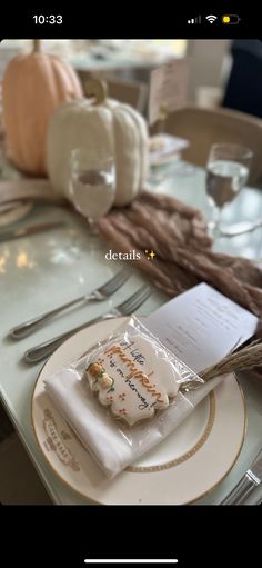 a white plate topped with a piece of cake on top of a table next to silverware