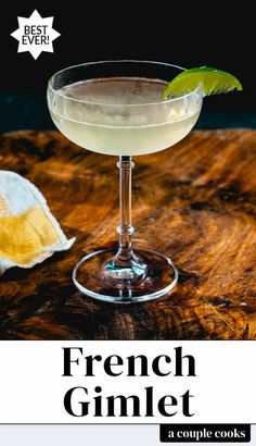 a glass filled with a drink sitting on top of a wooden table