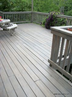 a wooden deck with two benches on it