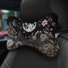 the back seat of a car with a decorative pillow on it's headrest