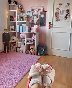 a child's bedroom with pink carpet and shelves full of stuffed animals on the floor